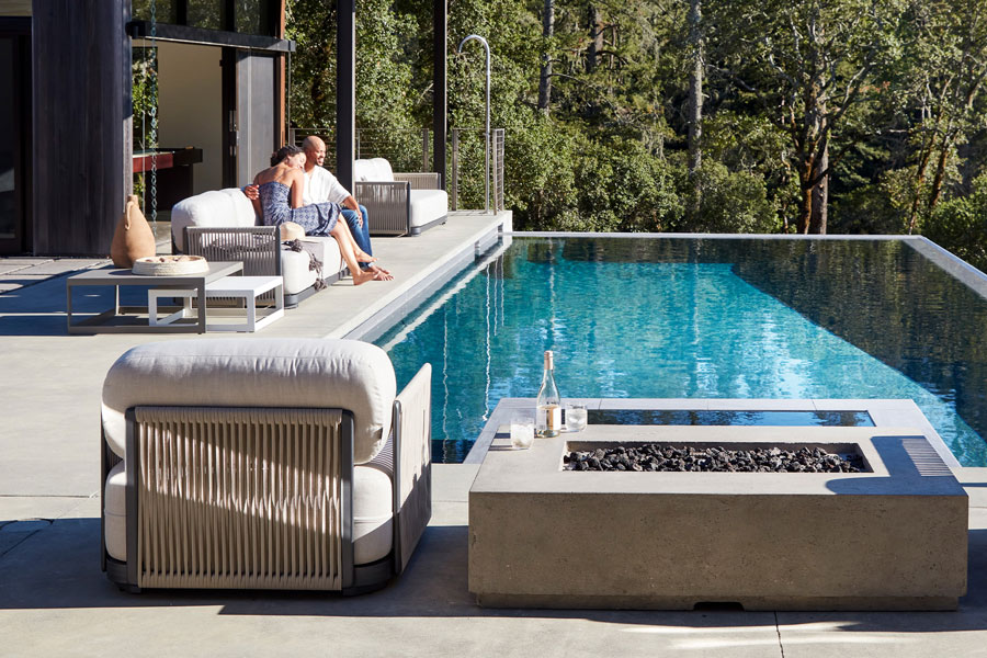 fire table poolside brings year-round warmth to patio