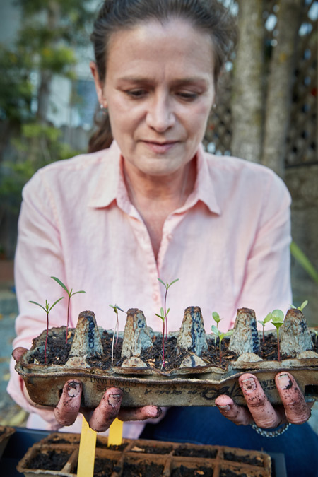 woman holding milkweed sprouts