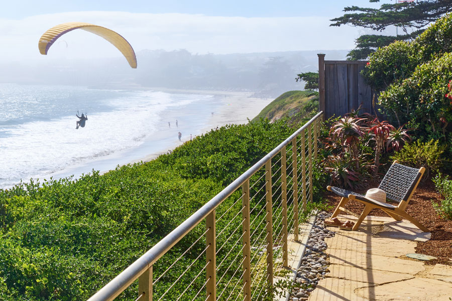Solana relaxing chair with view of paraglider and Santa Cruz beachfront in background