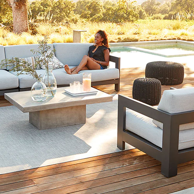 backyard entertaining space with sectional and coffee table for mobile