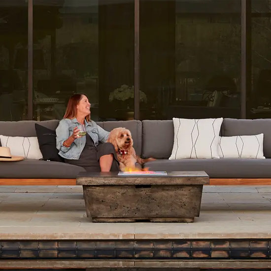 mobile view of Contempo fire table in dark basalt with Belvedere sectional in teak