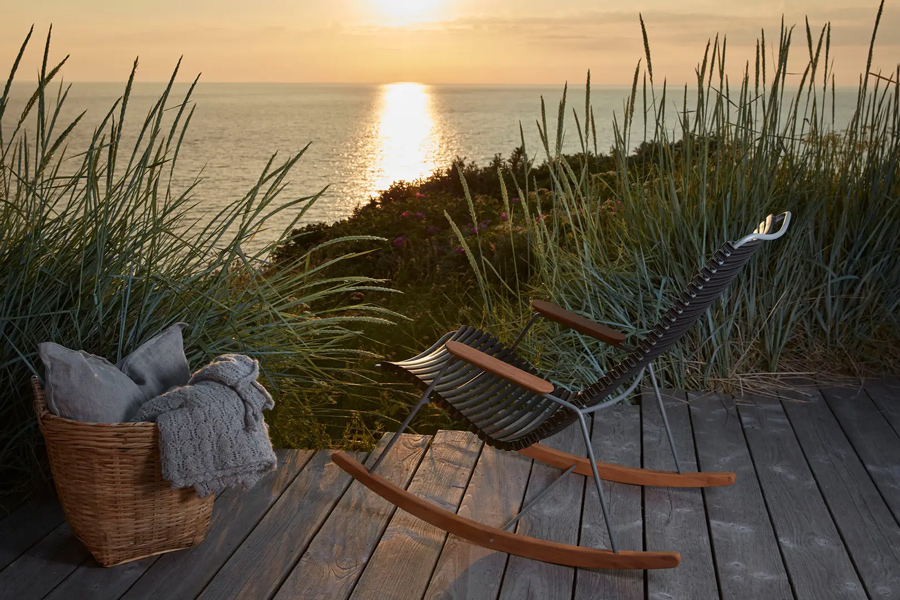 scandinavian outdoor furniture at sunset by water