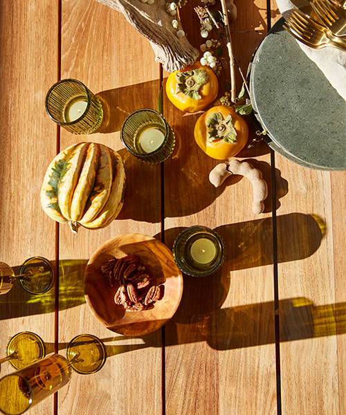 Top-down photograph of Holiday spread on Madera Vintage Beam Teak table.