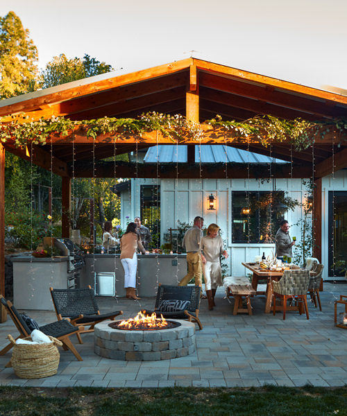 holiday gathering under a covered outdoor living space