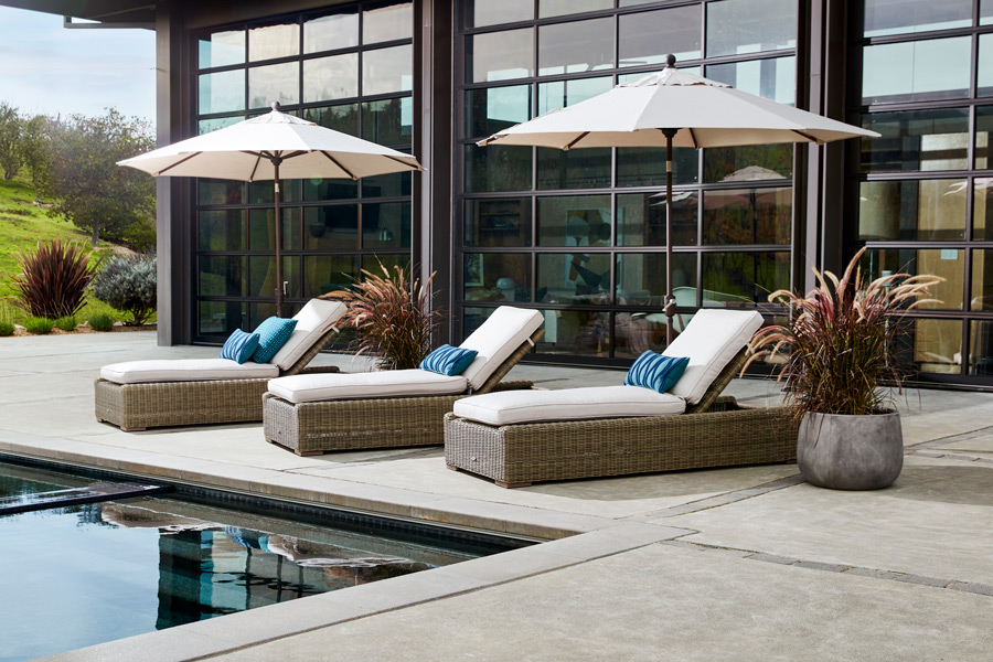 two market umbrellas and three chaise loungers adjacent to pool
