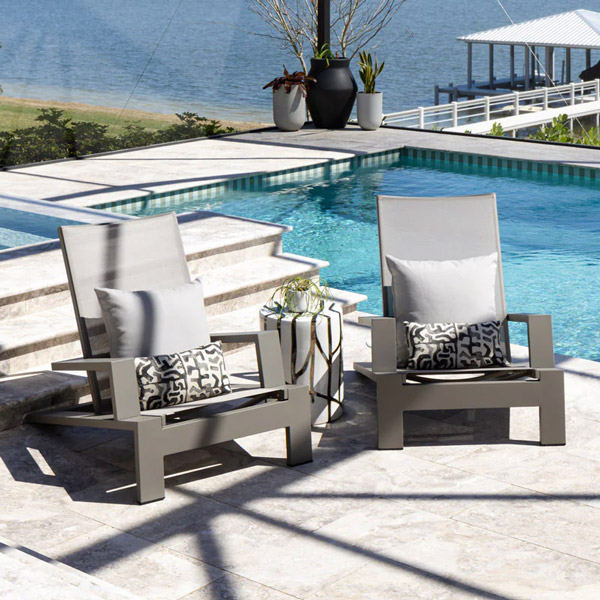 cushionless adirondack chairs with lumbar pillows in Florida sunroom by pool