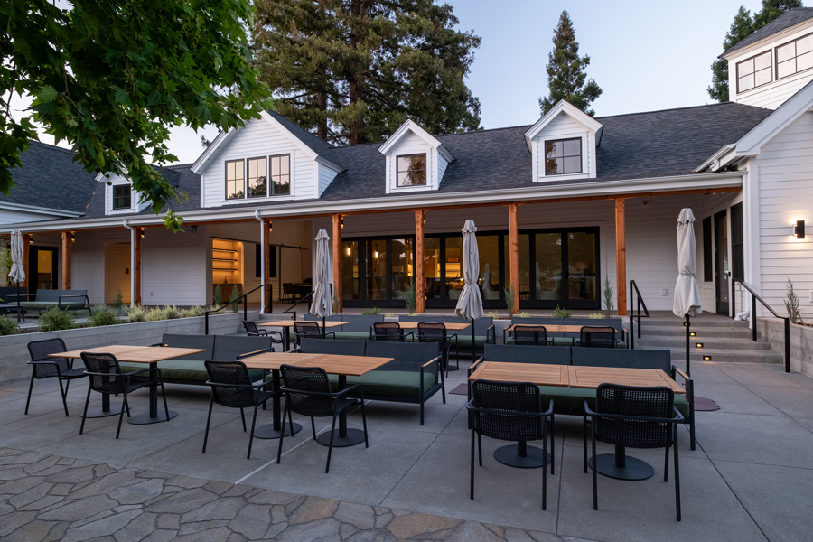 Pasadena loveseats and other outdoor furniture in mixed lounging and outdoor dining space at Napa winery