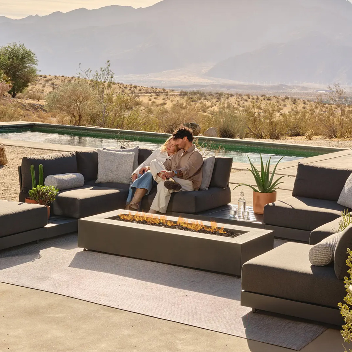 The Aspen Fire Table provides poolside warmth surrounded by Calabasas sectional pieces.