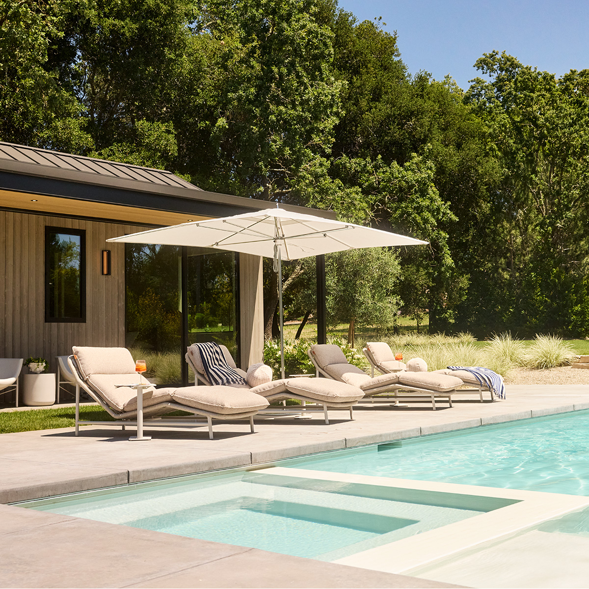 Silverado chaises shaded by a TUUCI umbrella