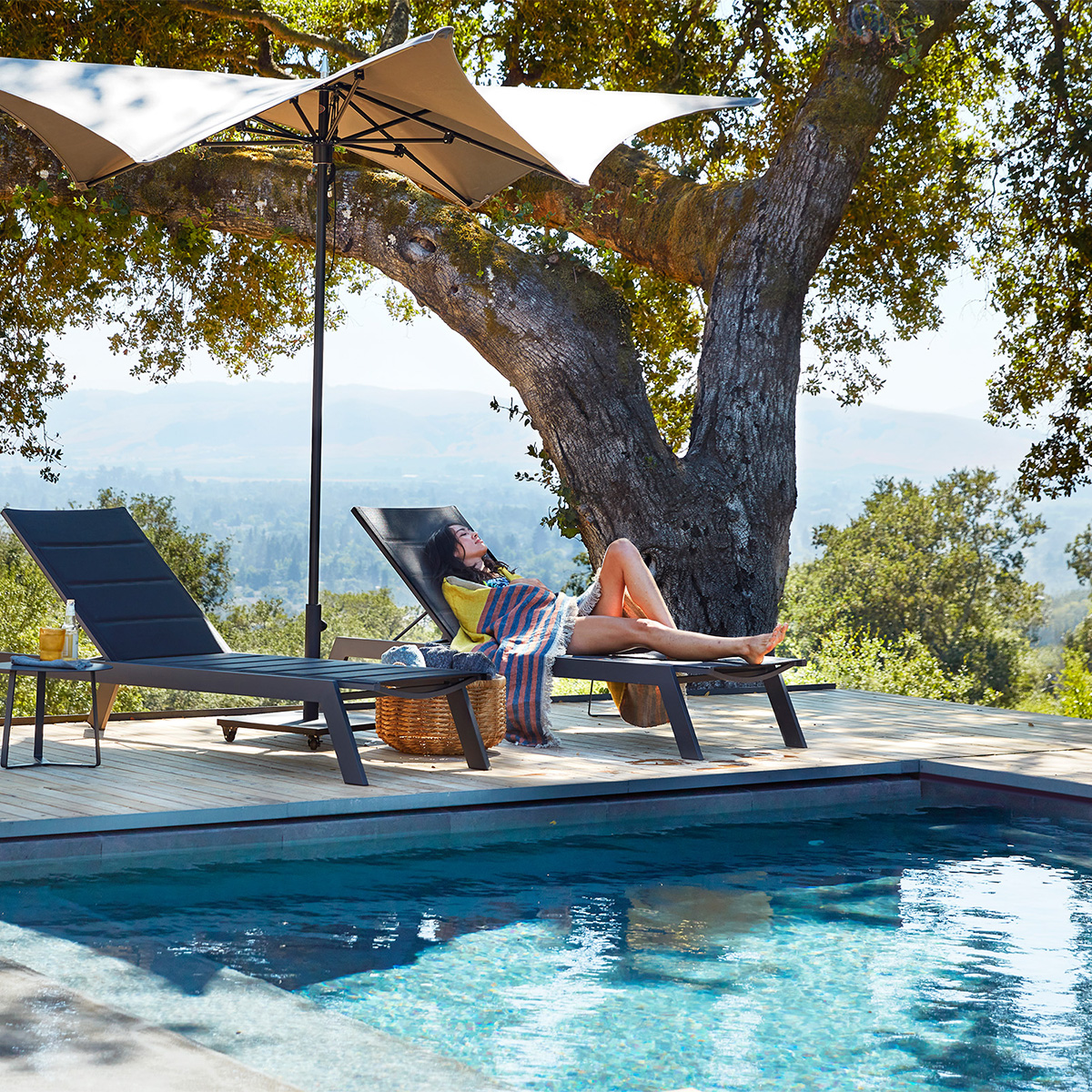 Tiburon chaises shaded by a TUCCI umbrella