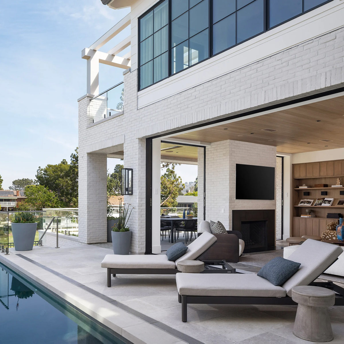 Stinson chaises in charcoal powder-coated aluminum at a Newport Beach estate